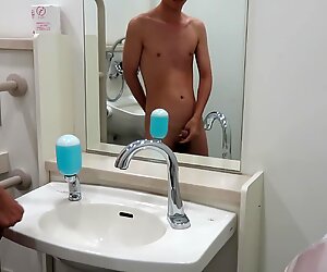 Japanese guy naked and pissing in public toilet